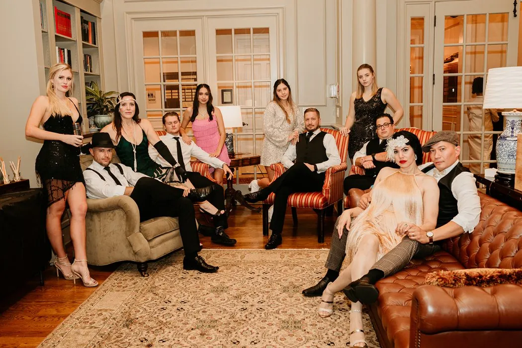 Guests in full 1920s attire lounging like a Gatsby portrait