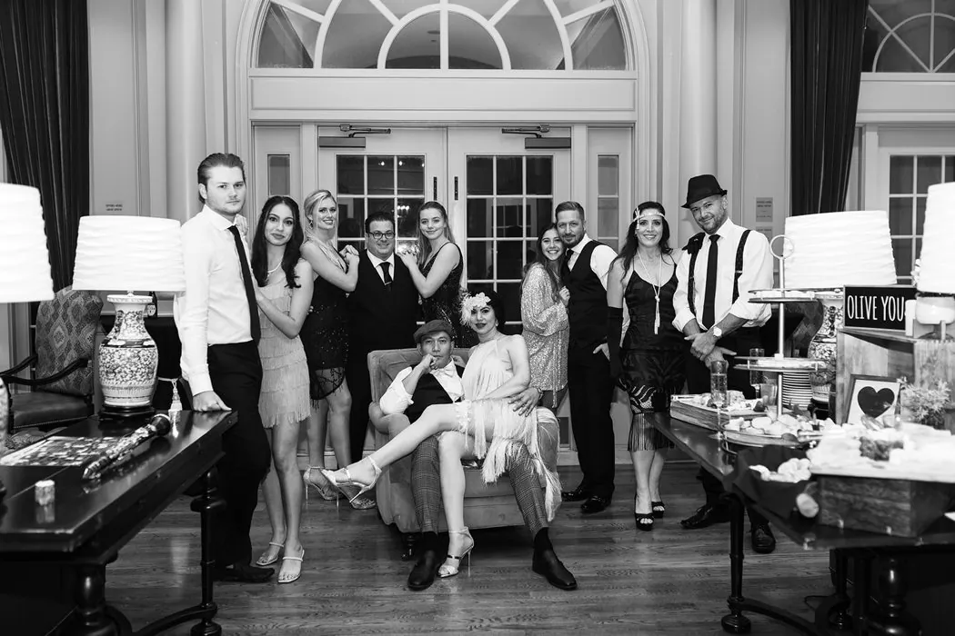 A black and white portrait of the flapper-era wedding party