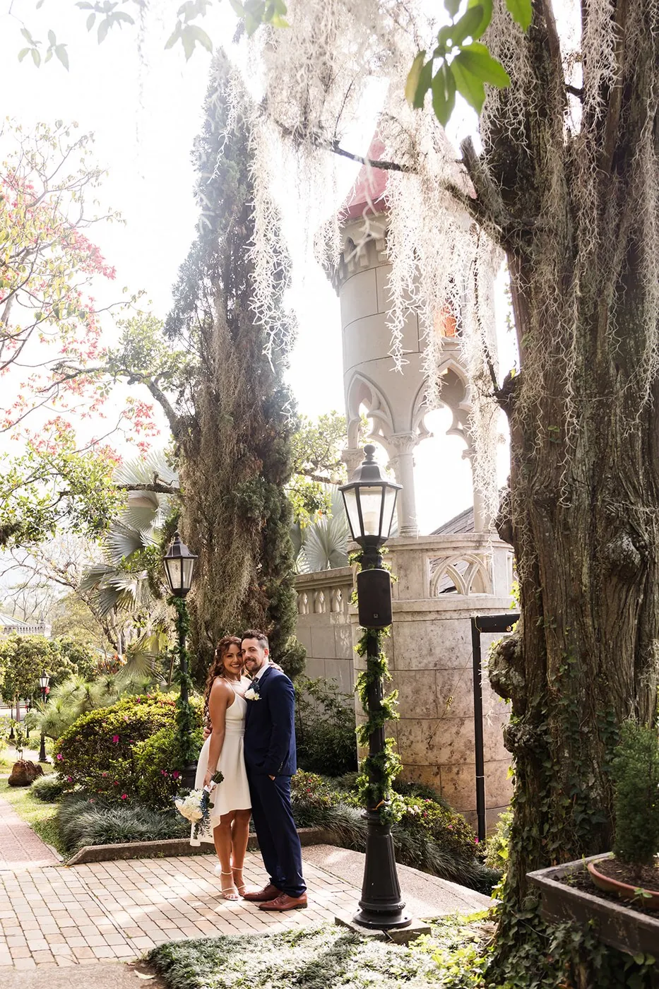 Nataly and Joey by the tower and gardens of El Castillo, a castle wedding in Medellin, Colombia