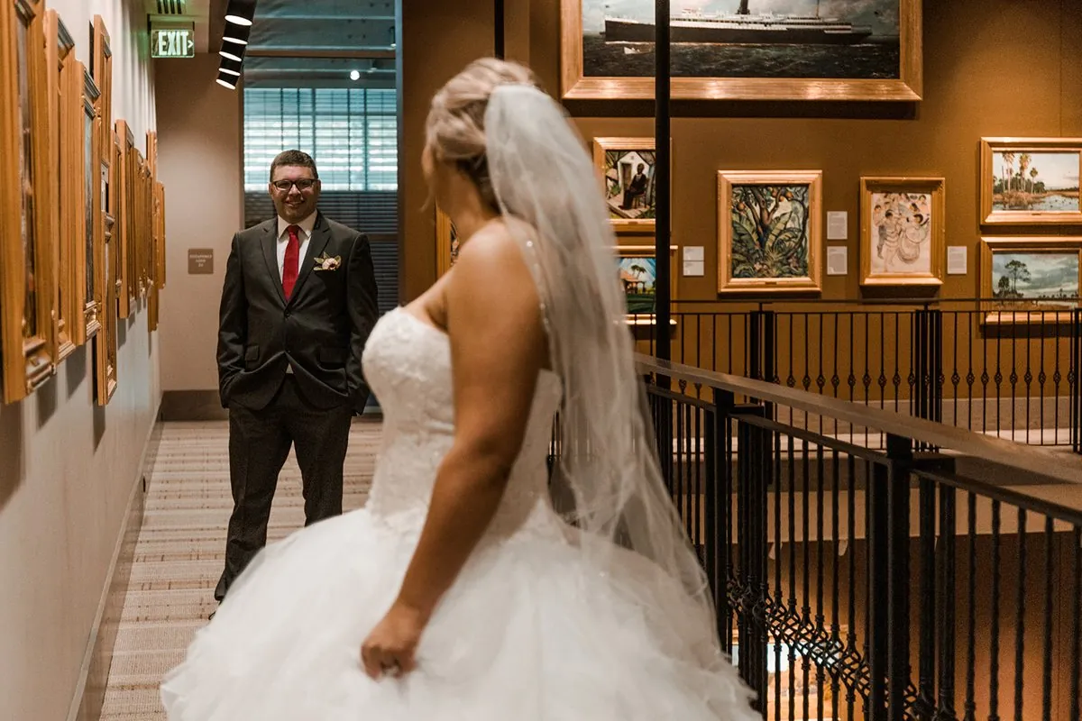 The groom seeing his bride in the gallery, a first look moment