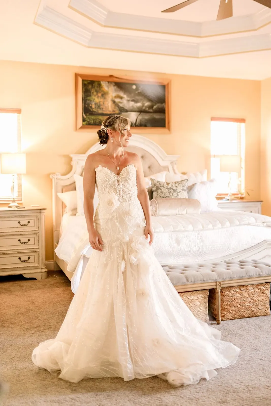 Bride in her gown getting ready before a backyard wedding