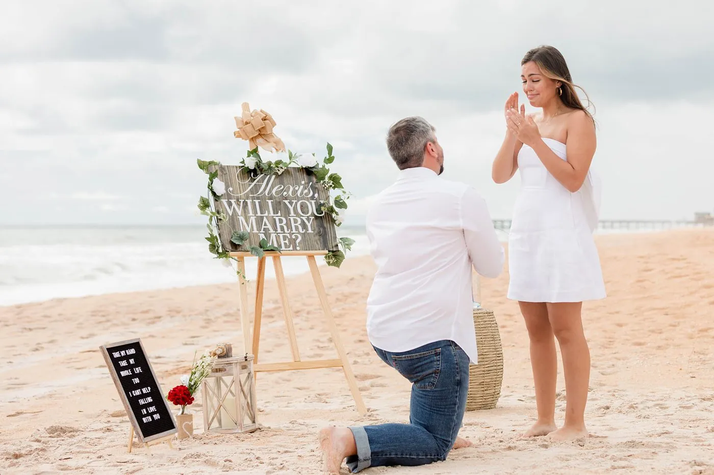 A beach proposal, everyone hiding to celebrate