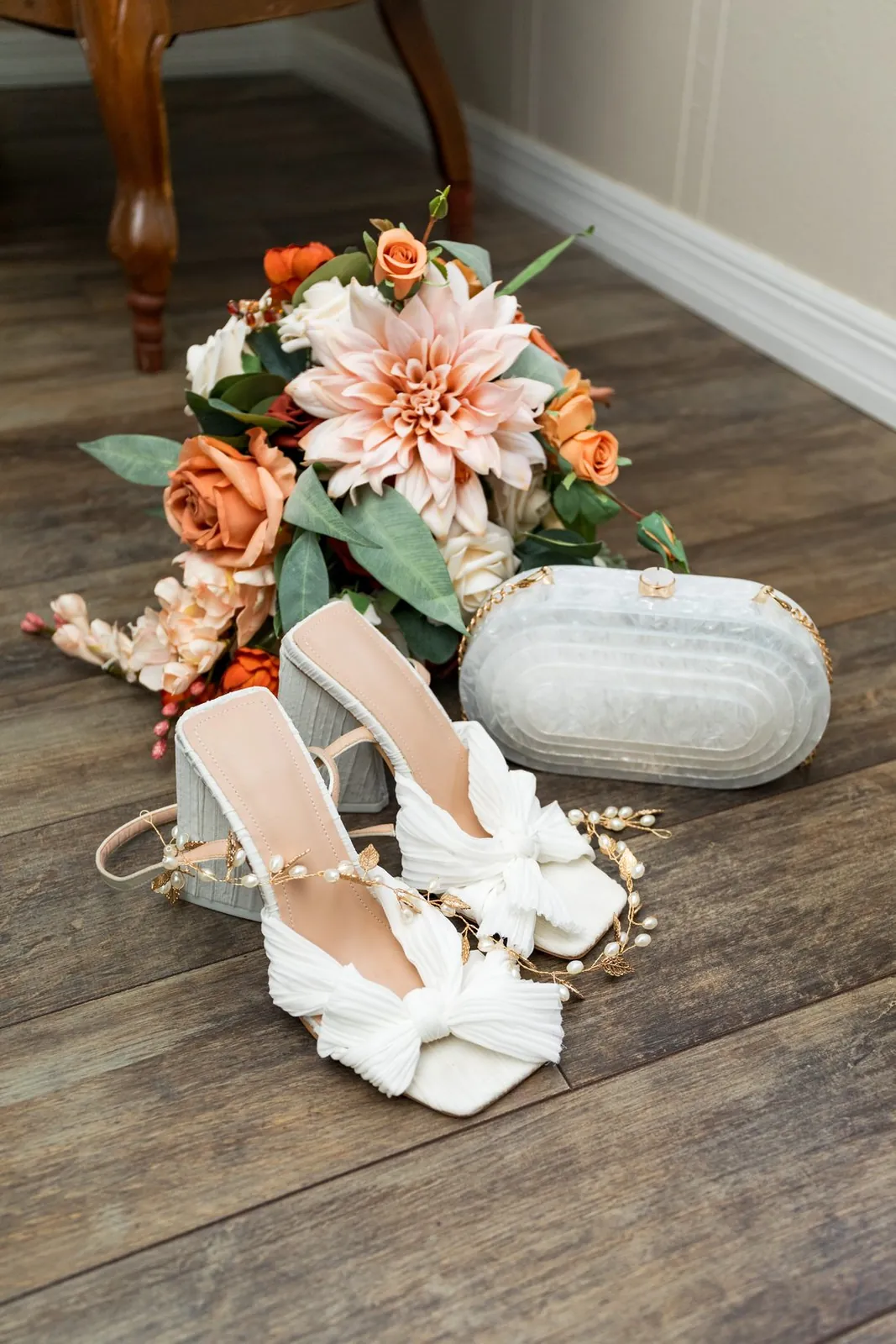 Bridal shoes, bouquet, and clutch
