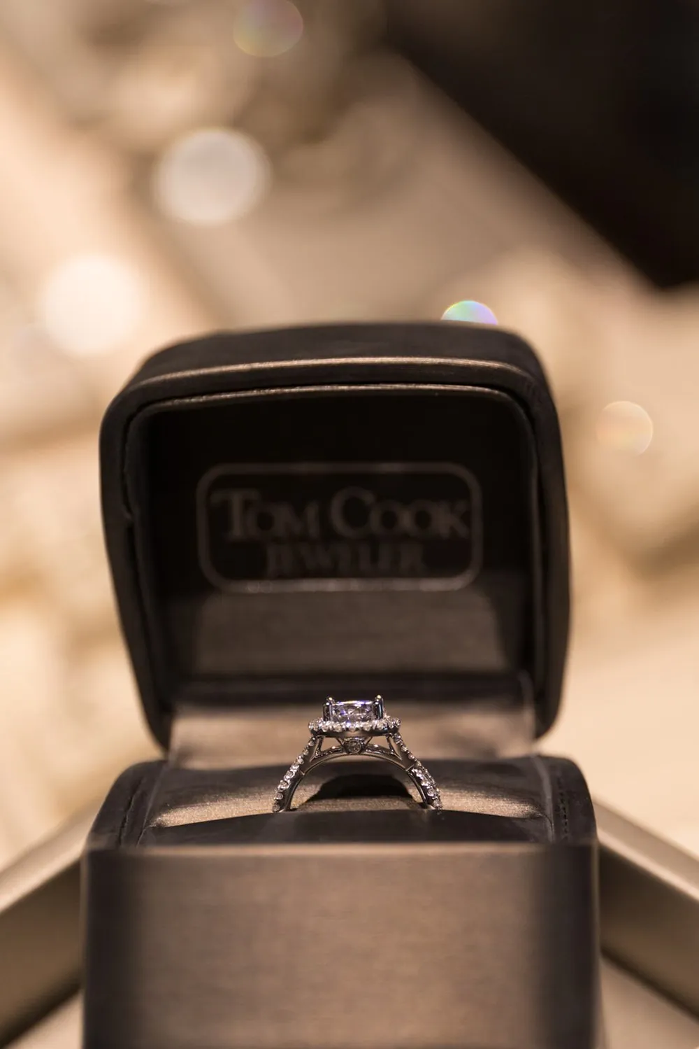 An engagement ring displayed in a Tom Cook Jeweler ring box