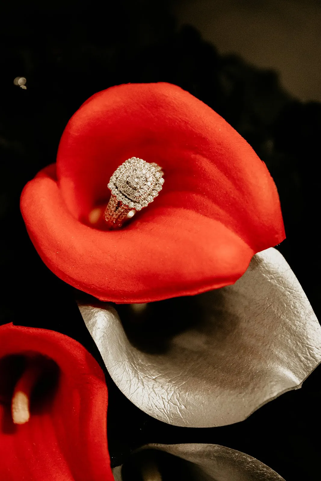 A diamond ring nestled inside a red calla lily