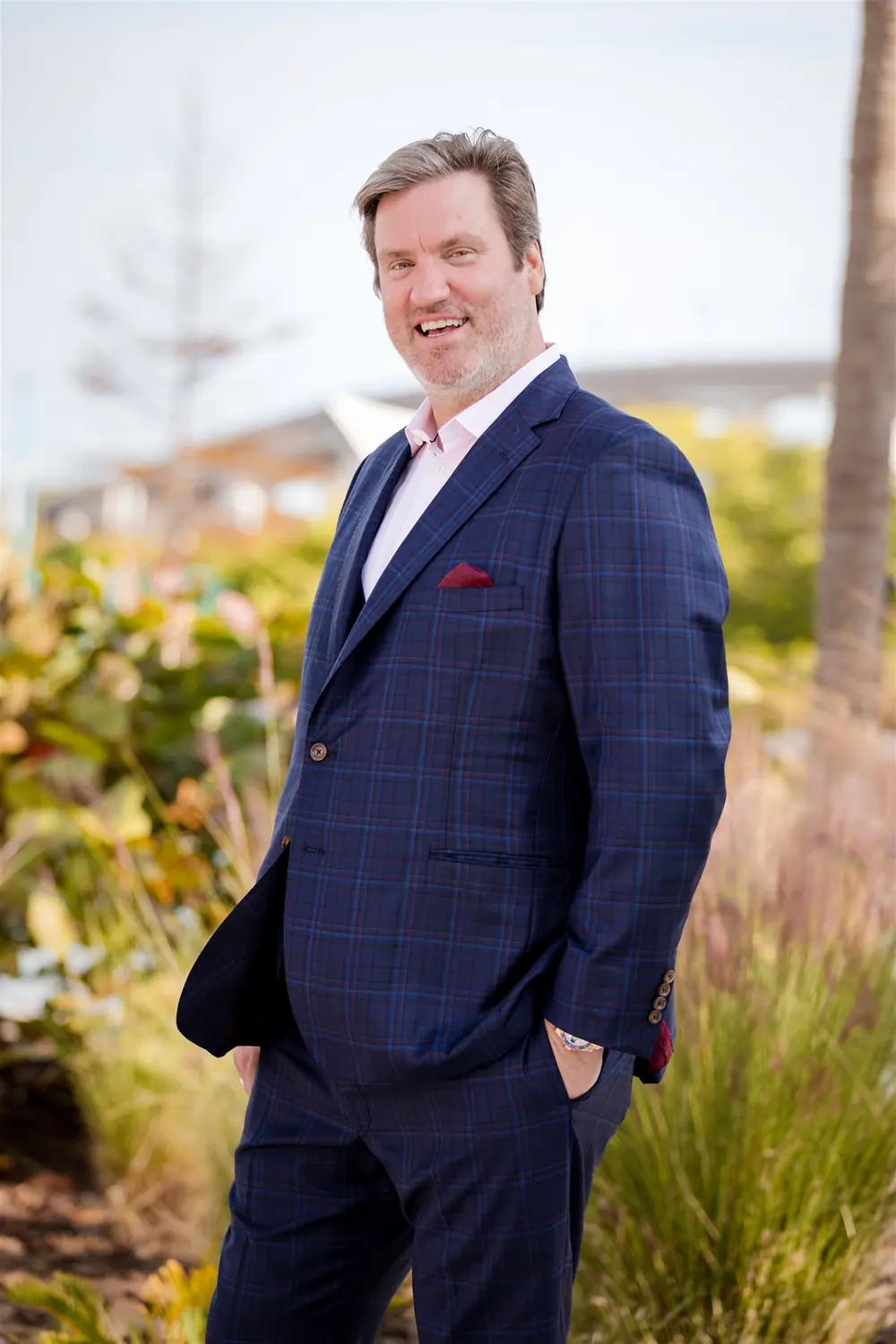 A professional headshot session for an insurance executive, photographed outdoors