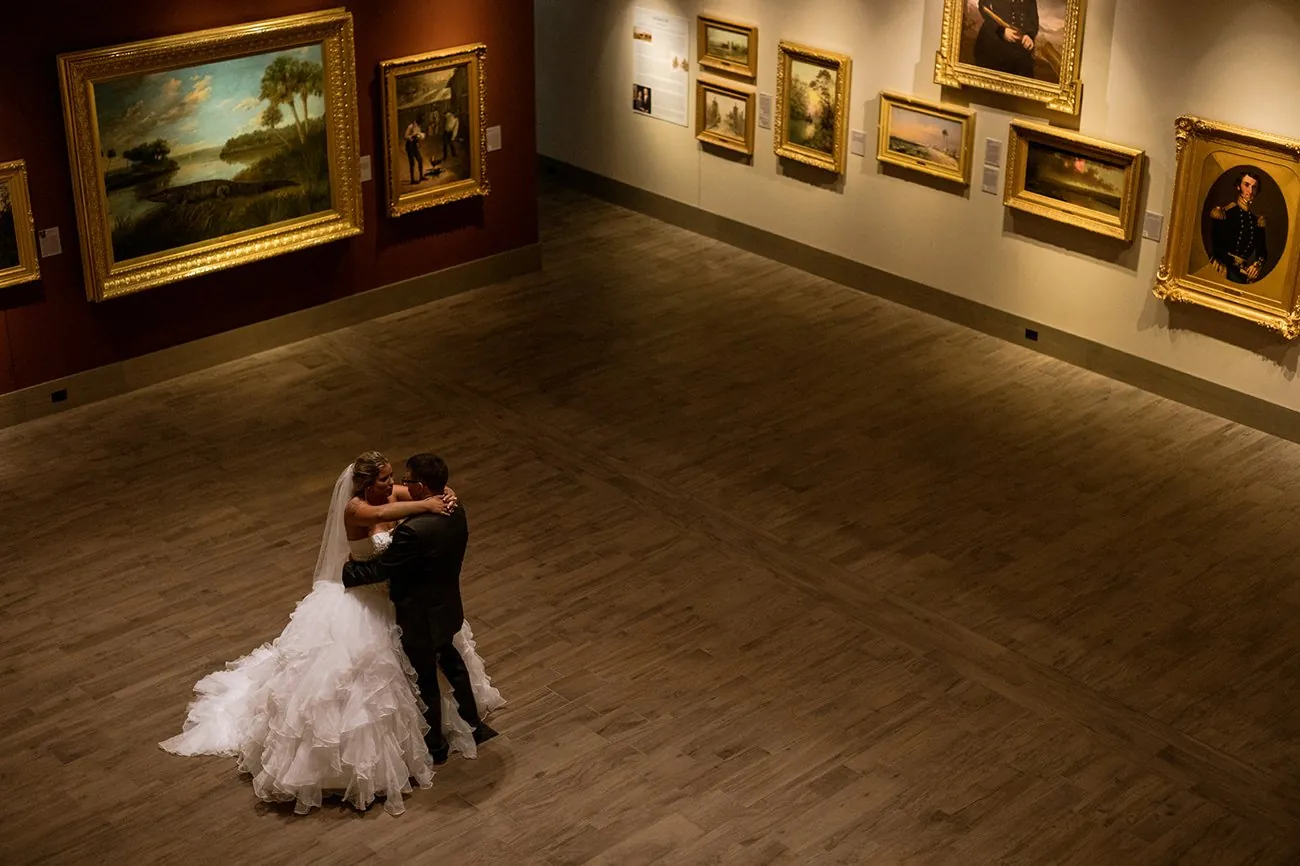 From above, Haley and Matt hold each other in the vast museum gallery