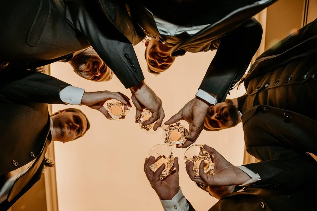 The groomsmen raising a toast, shot from below