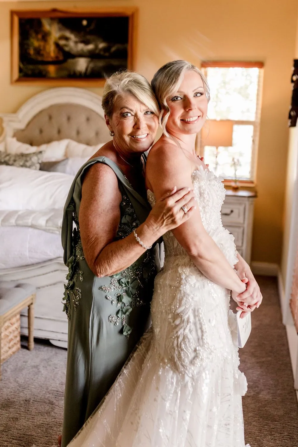 Bride and her mother in a tender getting-ready moment before an intimate wedding
