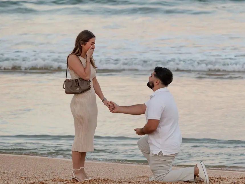 A beachfront proposal at sunset