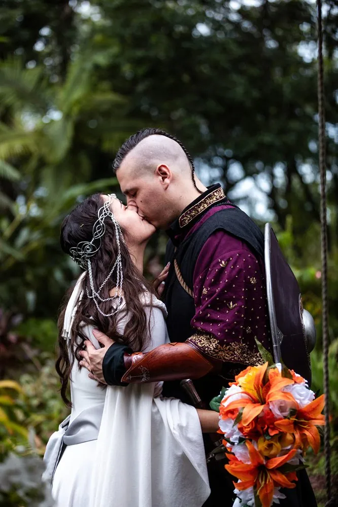 The couple kissing in the forest, the bride in a silver circlet