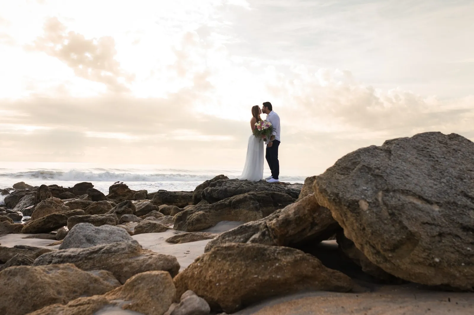 Sunset wedding kiss on the rocks, Florida's Historic Coast