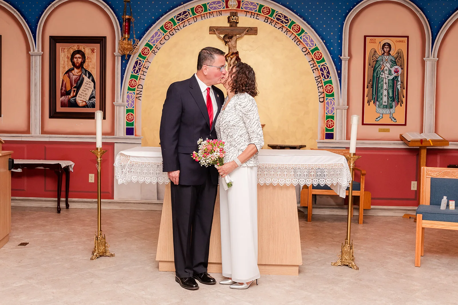 A couple sharing a kiss during their church vow renewal