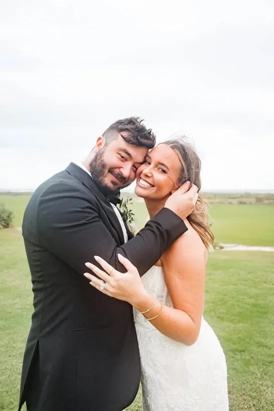 Rachel and Josh cheek to cheek on their wedding day
