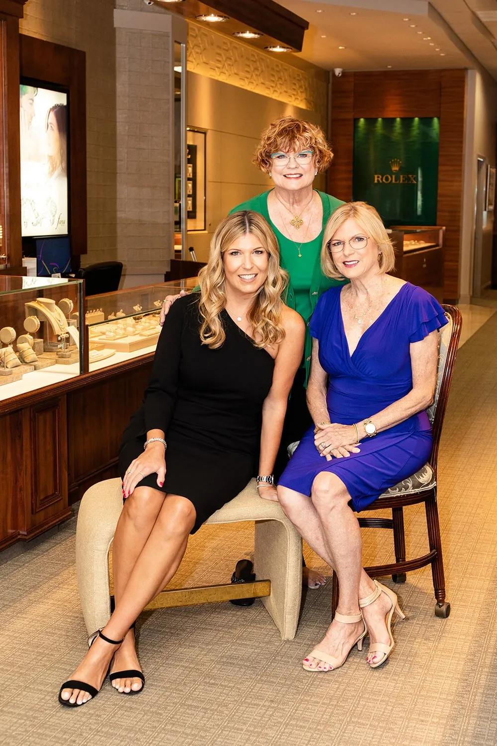 The three women of a family jewelry business, seated in their showroom