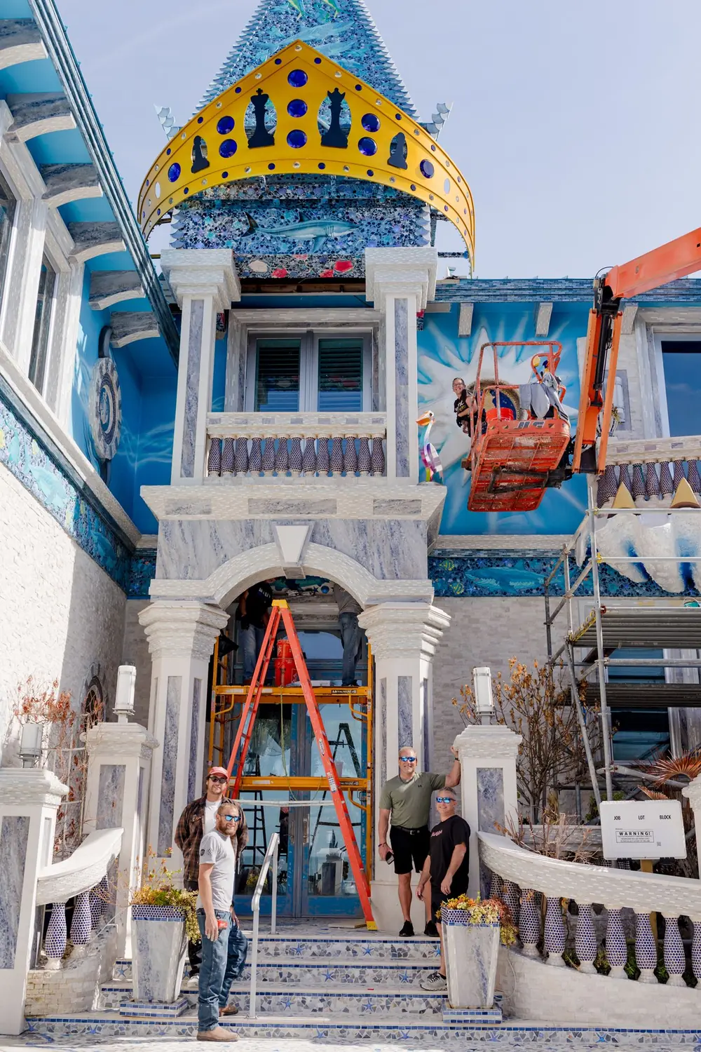 The mosaic castle home of Frank Russo with its crown tower and build crew