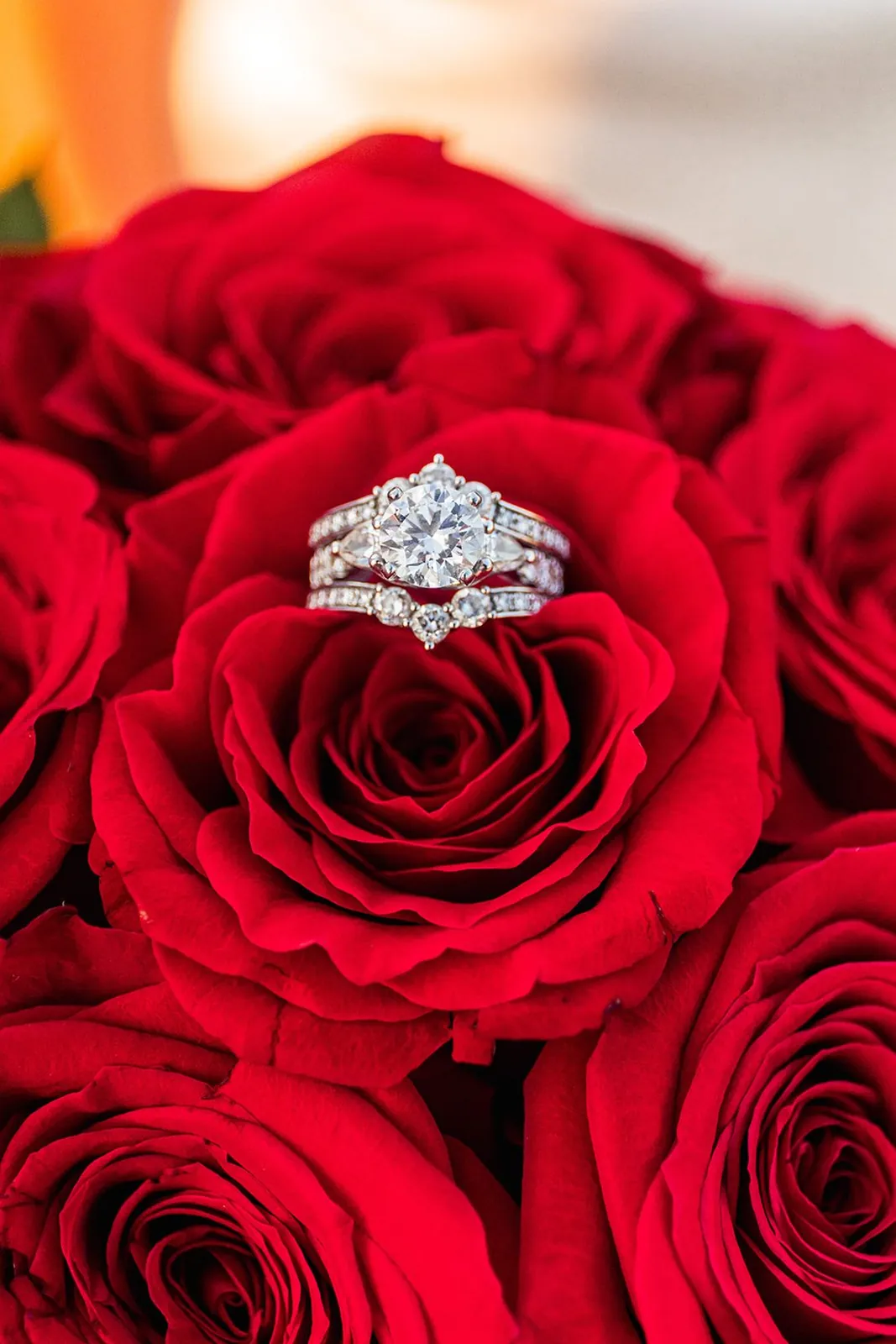 Wedding ring nestled in red roses