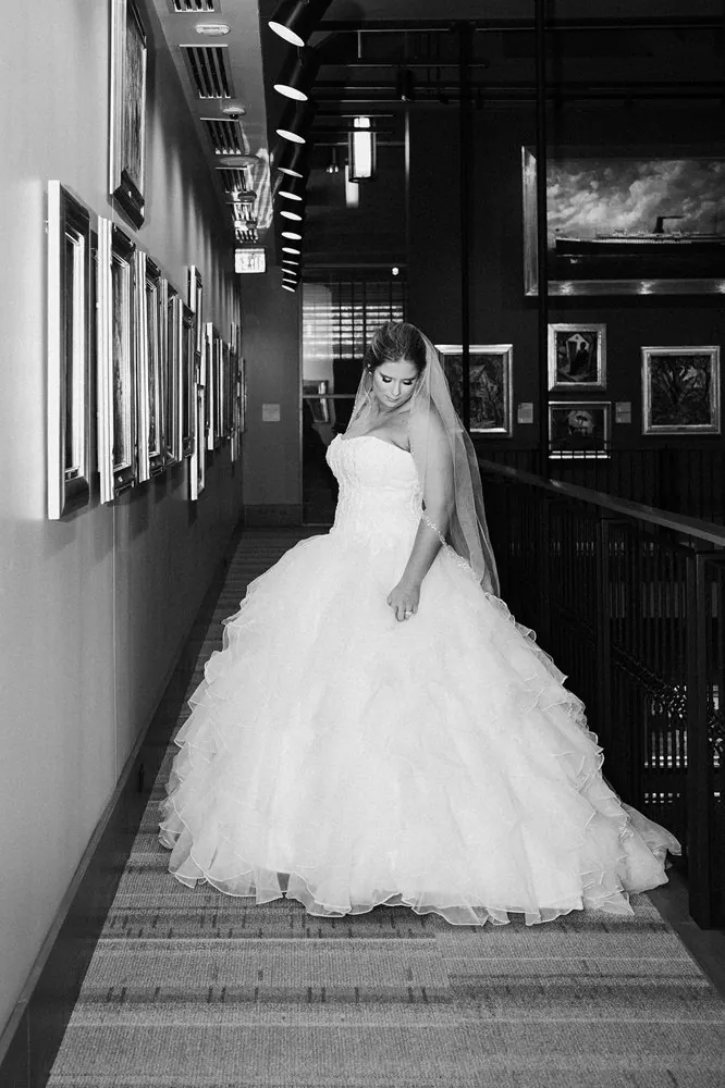 The bride in black and white among the museum's framed paintings